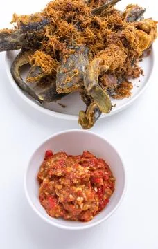 Deep fried crispy catfish served with spicy red chili paste sambal isolated.. Stock Photos