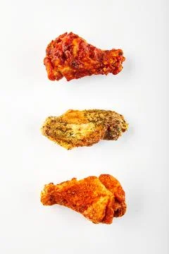 Deep fried Crispy chicken wings with different flavors and sauces on white .. Stock Photos