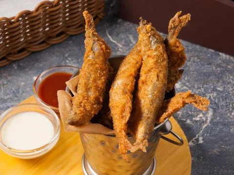 Deep-fried crispy fish with tomato and garlic sauce. Concept: snack to beer Stock Photos