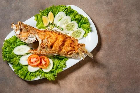 Deep fried crispy grouper fish with sambal dabu dabu Stock Photos