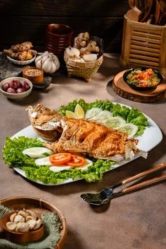 Deep fried crispy grouper fish with sambal dabu dabu Stock Photos