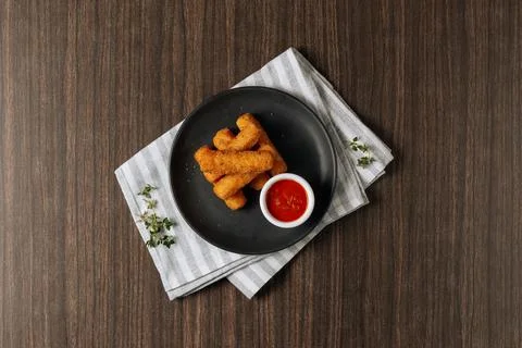 Deep fried crispy mozzarella cheese sticks with tomato dipping sauce isolated Stock Photos