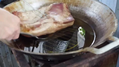 Deep-Fried Crispy Pork Belly Cooking in a Hot Wok with Boiling Oil Stock Footage 338211698