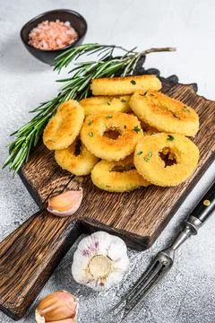 Deep fried crispy squid and onion rings breaded. White background. Top view Stock Photos