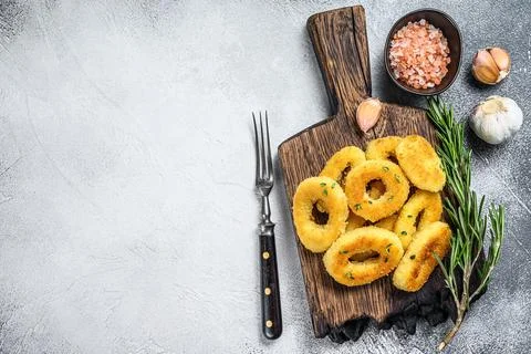 Deep fried crispy squid and onion rings breaded. White background. Top view Stock Photos