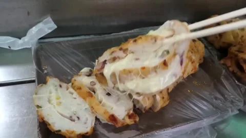 Deep Fried Korean Fish Cake Bar with Gooey Melted Cheese Stretch - Korean Street Stock Footage 337374698