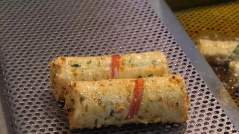 Deep-fried Korean Fish Cake Rolls (Hot Bar) Cooking in Hot Oil Stock Footage 337375032