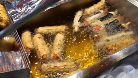 Deep fried Korean fish cakes cooking in hot boiling oil Stock Footage 337374503