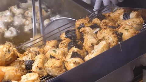 Deep Fried Korean Fish Cakes wrapped with Seaweed Strip on Metal Rack Stock Footage 337374529