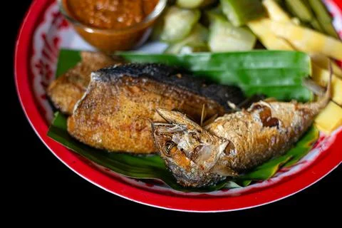 Deep fried mackerel in a vegetable dish. Stock Photos