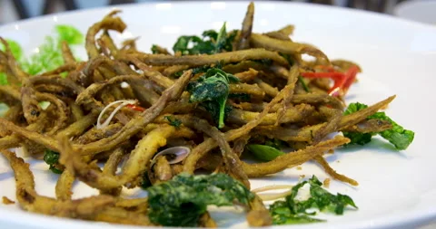 Deep Fried Minnow Fish with Salt and Sugar Fried Horse Face Loach or Fish fried Stock Footage 276571007