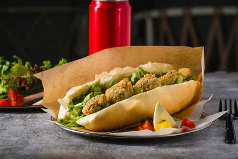 Deep fried mussels in bread and with greens on the side. Turkish name Midye.. Stock Photos