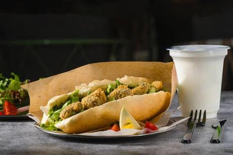 Deep fried mussels in bread and with greens on the side. Turkish name Midye.. Stock Photos