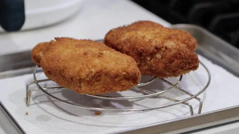 Deep fried pork chop in a rack, 4k, homemade food, kitchen Stock Footage 252166108