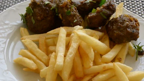 Deep fried potato with chicken nuggets low hard light Stock Footage 163077904
