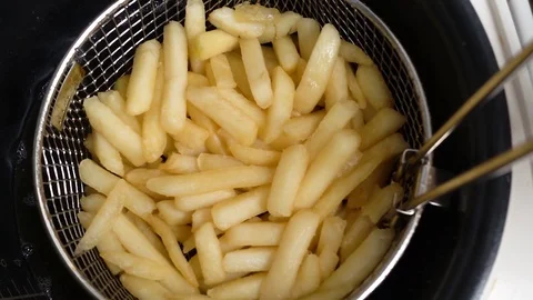 Deep fried potatoes in boiling oil. Preparation of raw potatoes. Stock Footage 122690236