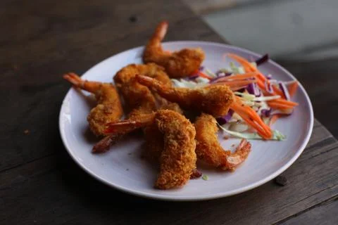 Deep fried prawn in breading close up photo on the wooden table Stock Photos