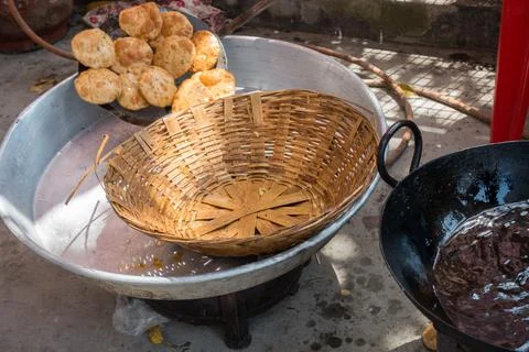 Deep fried Puri or Poori being made traditionally with bamboo basket during a 스톡 사진