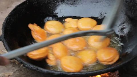 Deep fried round dough in the hot oil Stock Footage 162971098