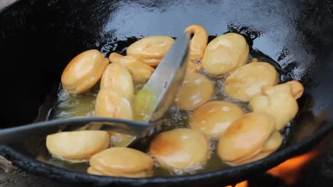 Deep fried round dough in the hot oil Stock Footage 162971228