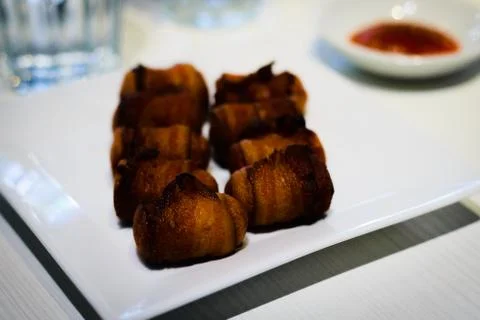 Deep fried sausage wrapped in bacon Stock Photos