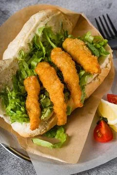 Deep fried shrimp in bread with greens on the side. Shrimp sandwich Stock Photos
