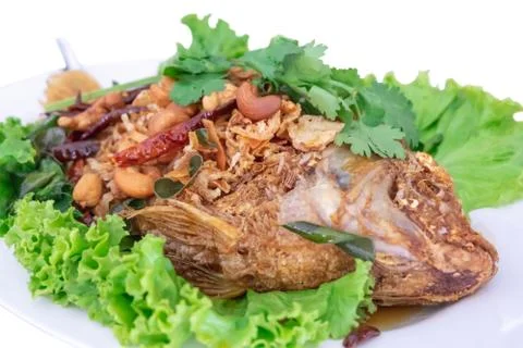 Deep fried snapper topped with fish sauce isolated on white background Stock Photos