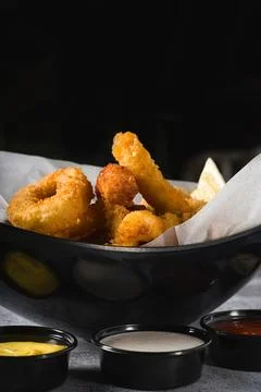 Deep fried squid, shrimp and mussels with sauces on the side Stock Photos