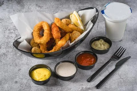 Deep fried squid, shrimp and mussels with sauces on the side Stock Photos