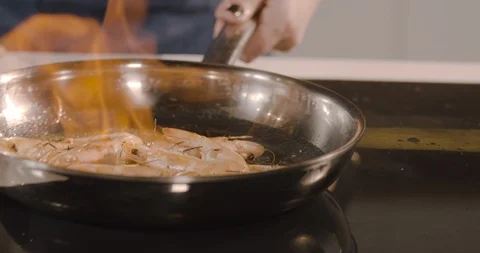 Deep fried tiger shrimps preparing on frying pan with flame at kitchen. Stock Footage 124005963