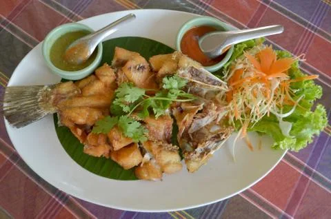 Deep fried whole white seabass with sauce Stock Photos