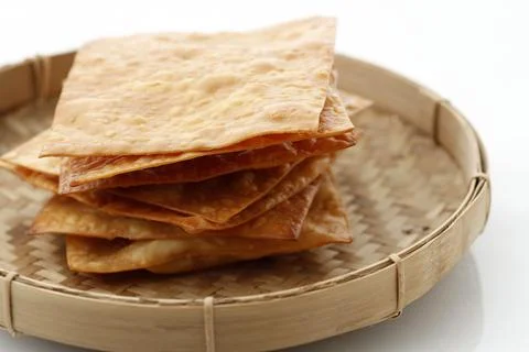 Deep Fried Wonton Wrapper Sheet or Pangsit Goreng, Crispy Dumpling for Crac.. Stock Photos