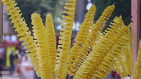 Deep fry potato chips strung together, deep fry spiral-shaped potato chips Stock Footage 322778645