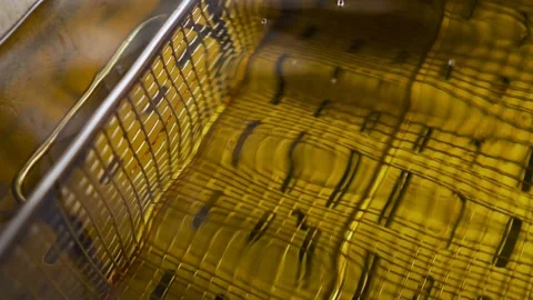 Deep fryer basket in boiling vegetable oil. Fast food. Stock Footage