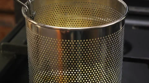 Deep fryer ladle with grid on burning stove Stock Footage 306548434