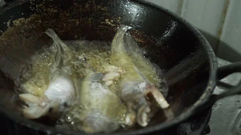Deep frying cat fish in hot oil cooking pan Stock Footage 156384830
