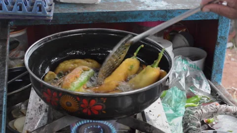 Deep frying chilli snack on street cart Stock Footage 159610896