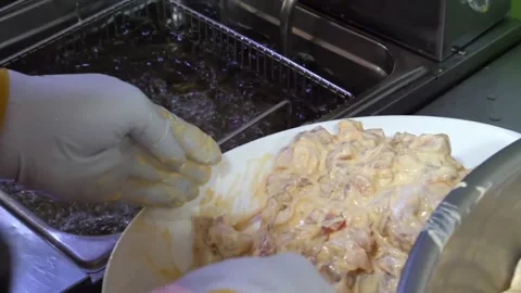 Deep Frying Crispy Chicken Battered in Creamy Sauce at Commercial Kitchen Video stock 343027099