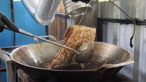 Deep Frying Crispy Pork Belly with Golden Crunchy Skin, Thai Street Food Style Stock Footage 338211723