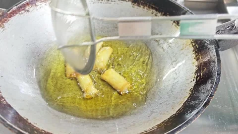 Deep frying crispy spring rolls in a hot wok. Stock Footage 342393035