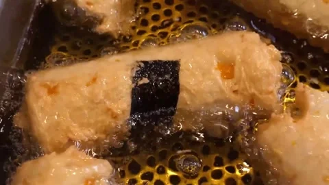 Deep Frying Delicious Korean Fish Cake Rolls in Hot Oil Stock Footage 337374993