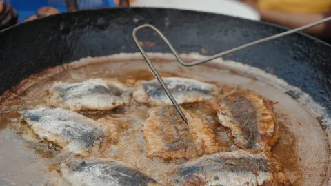 Deep frying fish close up cooking on street ramadan kareem market Stock Footage 108544961