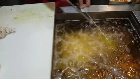 Deep Frying Fresh Korean Fish Cakes Eomuk at a Traditional Street Food Market Stock Footage 337373005