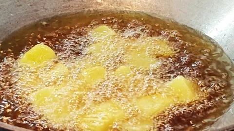 Deep frying fresh potato chunks inside a metal wok. Stock Footage 344555383