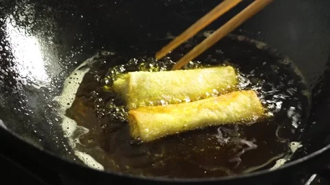Deep Frying Golden Spring Rolls in Hot Oil Wok Close Up Stock Footage 340775306