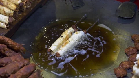 Deep frying kebab rolls in slow motion in Dhaka Stock Footage 152558934