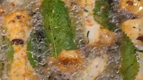 Deep Frying Korean Fish Cake Bars with Perilla Leaves - Close Up Footage Stock Footage 337374346