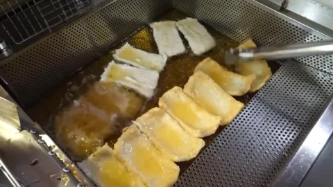 Deep Frying Korean Fish Cakes (Eomuk) in Hot Oil - Professional Kitchen Stock Footage 337374839