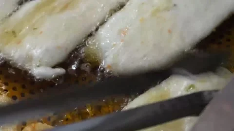 Deep Frying Korean Fish Cakes (Eomuk) at a Street Food Stall Stock Footage 337374863