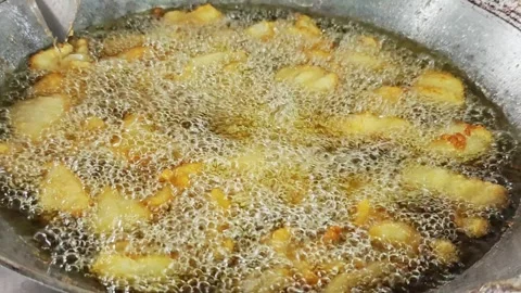 Deep frying large batch of crispy fish pieces in boiling oil. Stock Footage 342739588